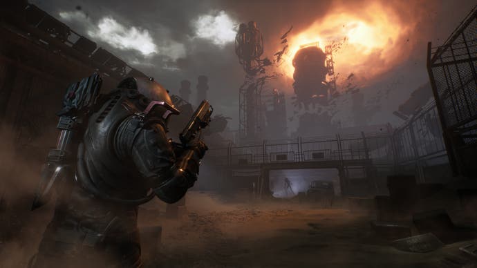 Cronos: The New Dawn screenshot showing person in suit walking towards an industrial facility on fire