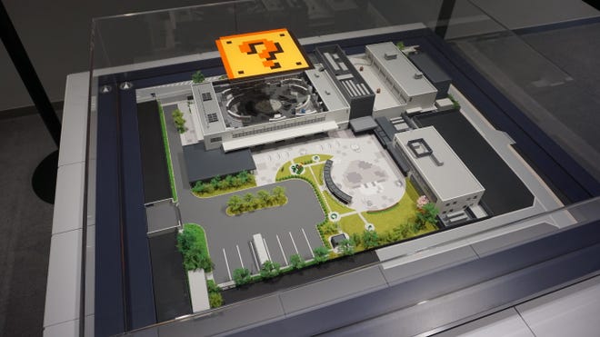 A photograph of a bird's eye model of the Nintendo Museum, with the roof lifted up to see inside.