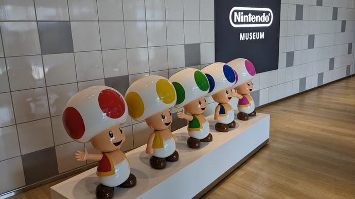 A photograph of five Toads in the entrance way of the Nintendo Museum.