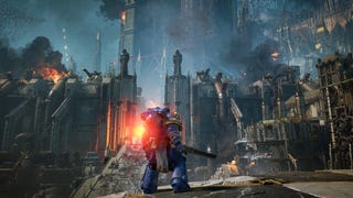 Space Marine 2 official image showing a marine with chainsword looking out over a gigantic gothic citadel, under siege with billowing smoke.