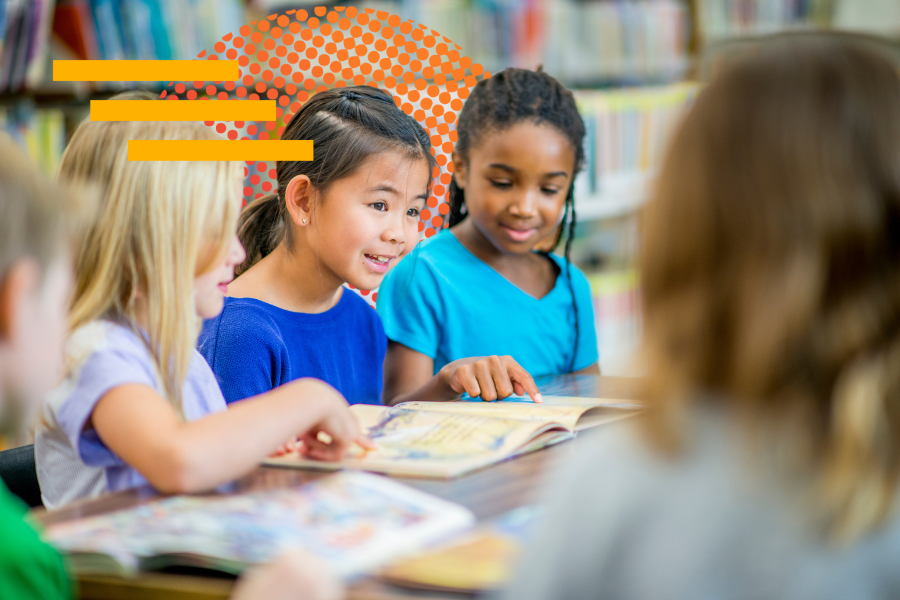 Children sit around a table in a classroom. 